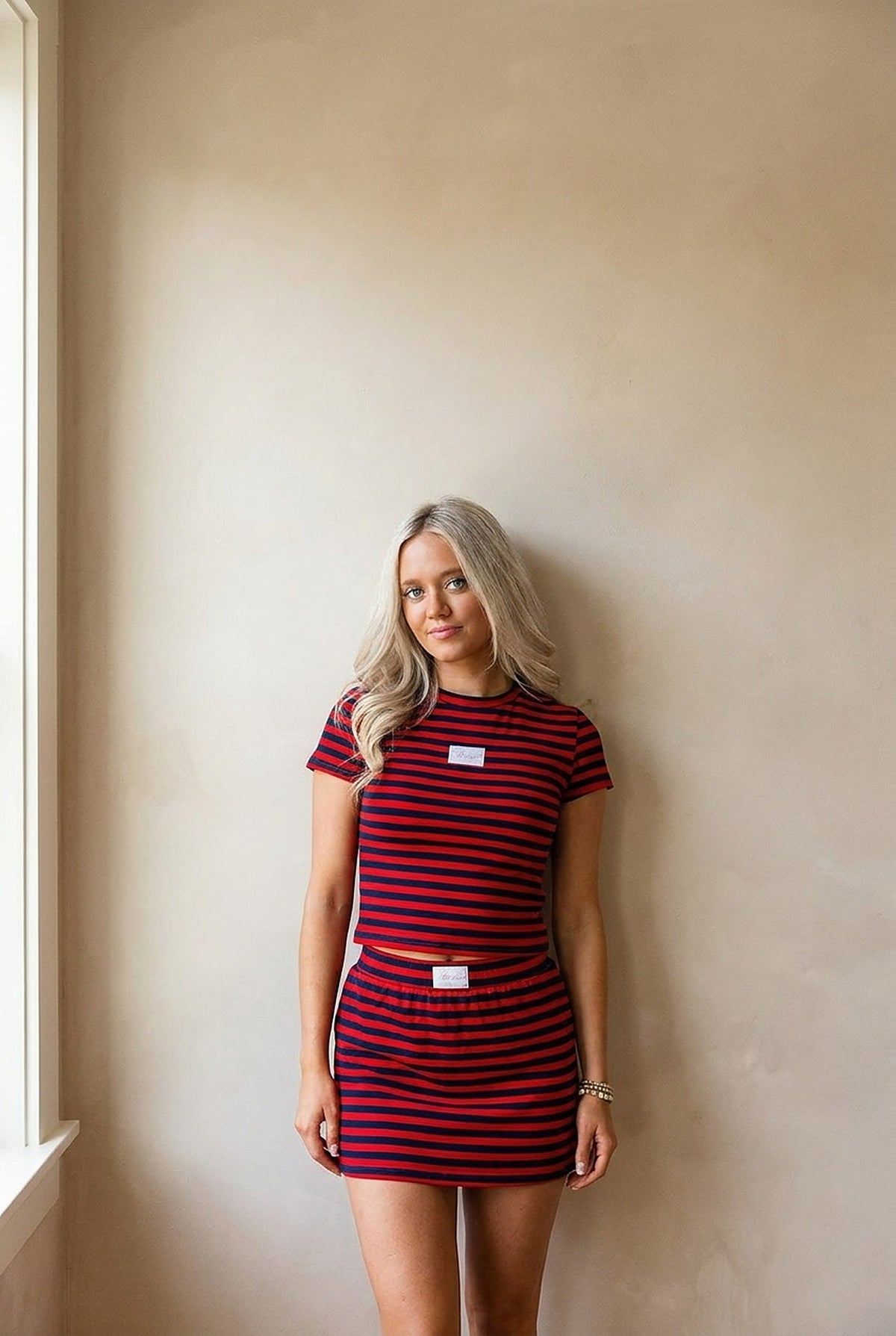 Woman wearing the red and navy Oxford Stripe Set